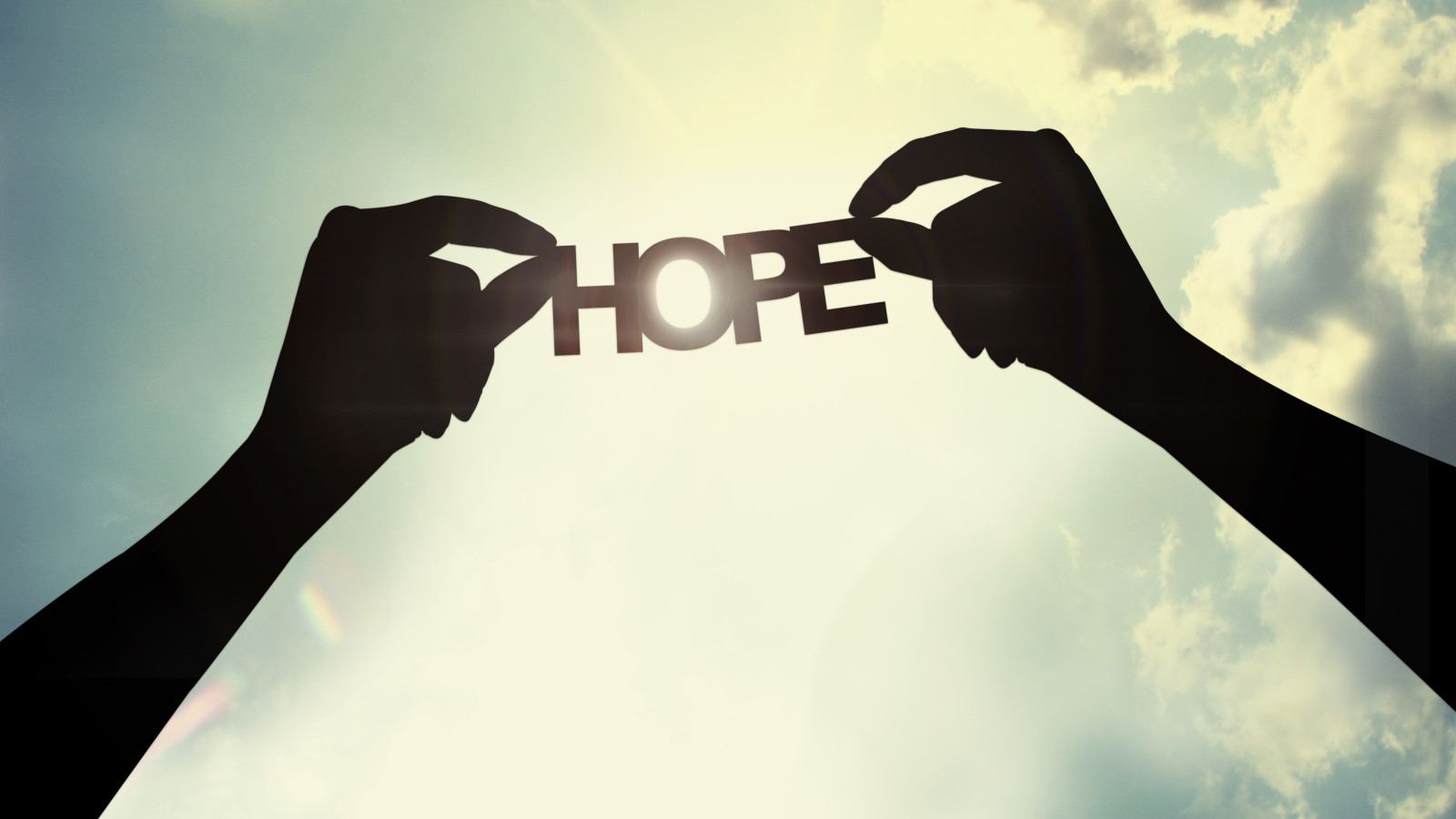 holding a paper cut of hope shutterstock_137307233